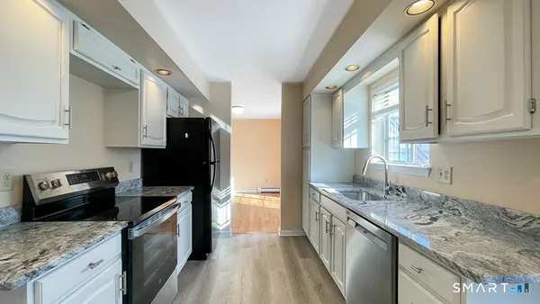 a kitchen with a sink stove and refrigerator