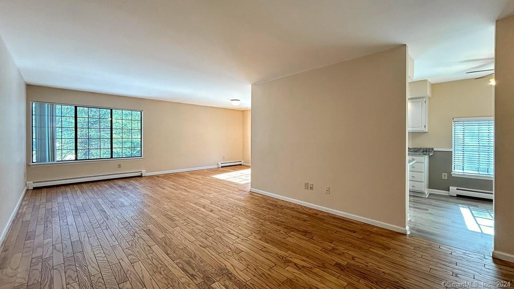 8 Derby Court, Unit 8 Brookfield, CT 06804 - Photo 26 of 26 wooden floor in an empty room with a window