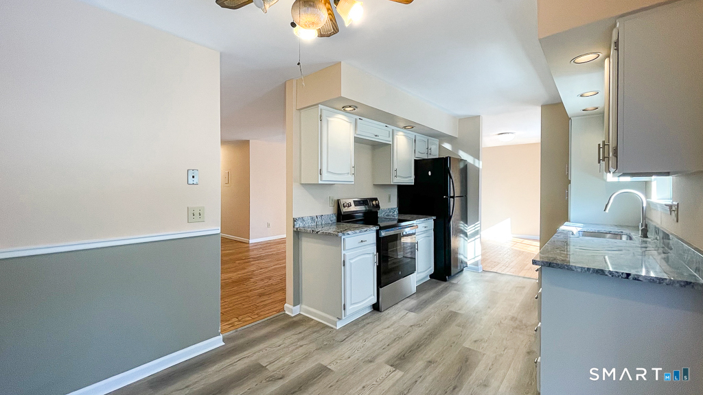 8 Derby Court, Unit 8 Brookfield, CT 06804 - Photo 7 of 26 a kitchen with stainless steel appliances granite countertop a refrigerator a stove top oven a sink and dishwasher
