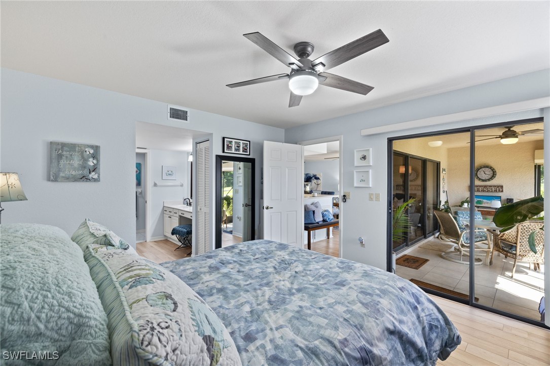 5925 Trailwinds Drive, Unit 912 Fort Myers, FL 33907 - Photo 17 of 39 a bedroom with a large bed and a large mirror