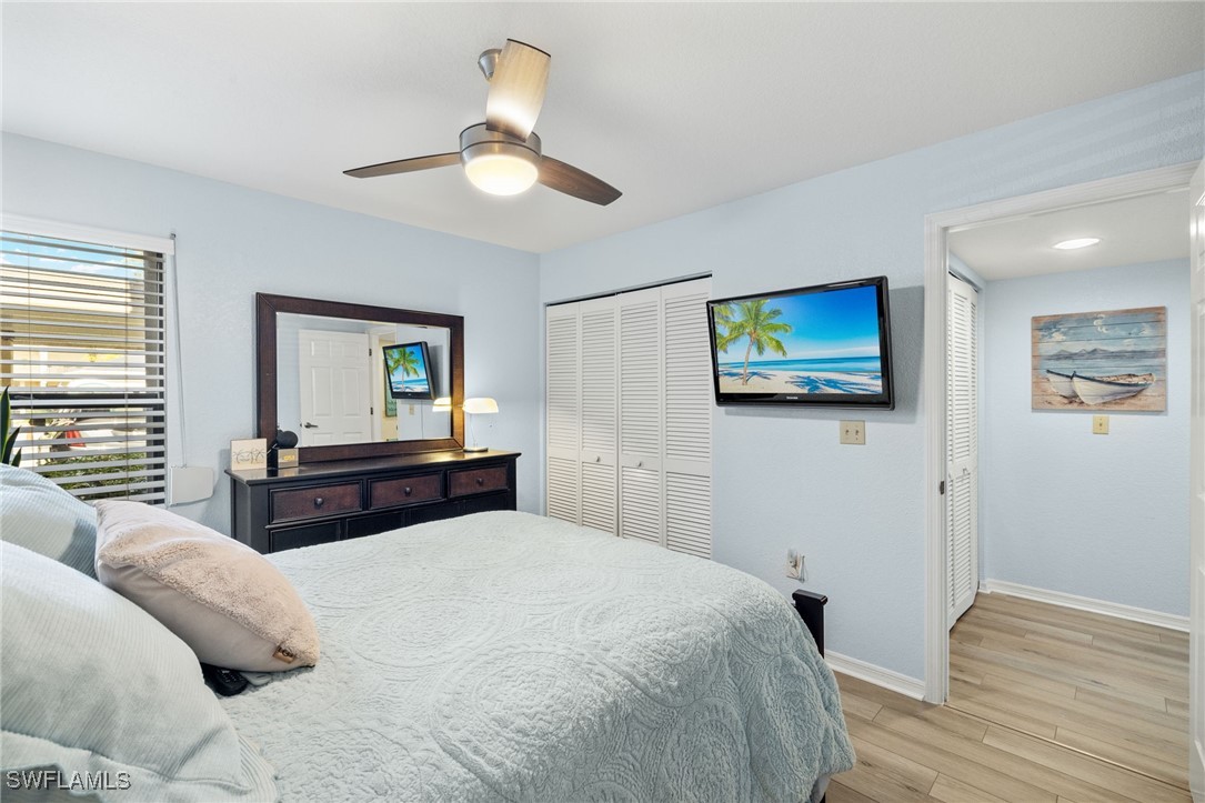 5925 Trailwinds Drive, Unit 912 Fort Myers, FL 33907 - Photo 21 of 39 a bedroom with a bed and a flat screen tv