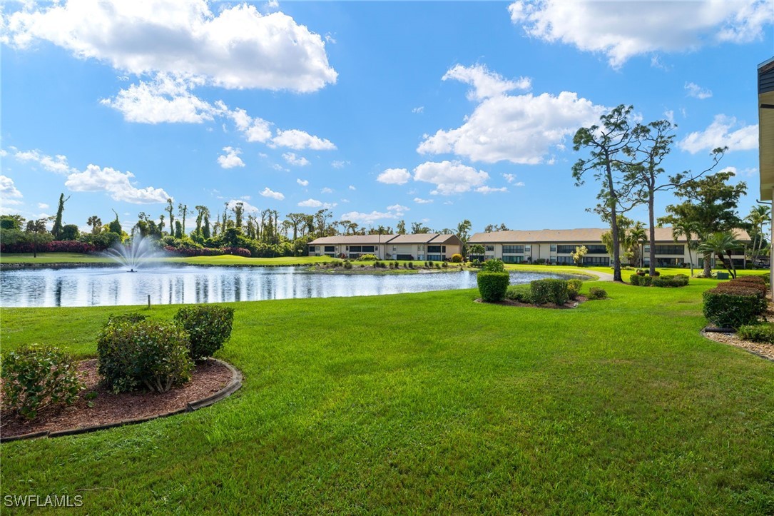 5925 Trailwinds Drive, Unit 912 Fort Myers, FL 33907 - Photo 24 of 39 a view of a lake with houses in the back
