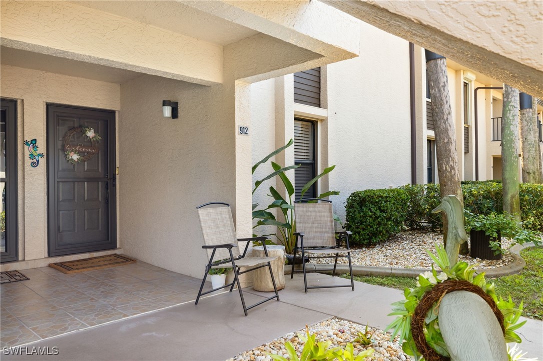 5925 Trailwinds Drive, Unit 912 Fort Myers, FL 33907 - Photo 3 of 39 a view of a house with backyard and sitting area