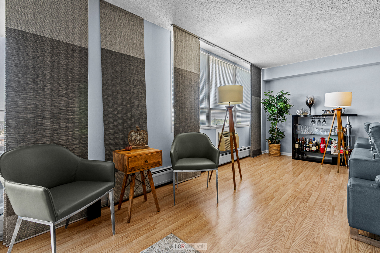 8815 West Golf Road, Unit 10C Niles, IL 60714 - Photo 14 of 27 a living room with furniture and a wooden floor