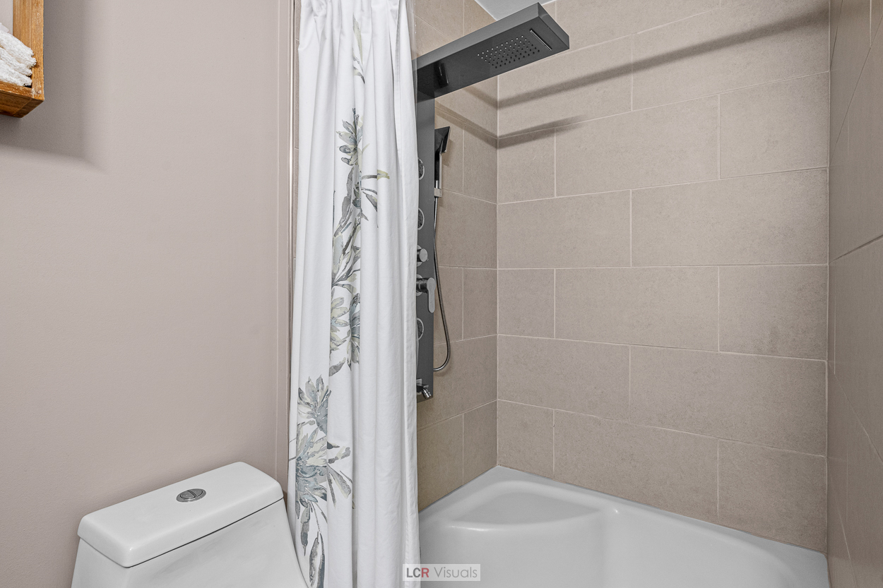 8815 West Golf Road, Unit 10C Niles, IL 60714 - Photo 17 of 27 a bathroom with a shower and a toilet