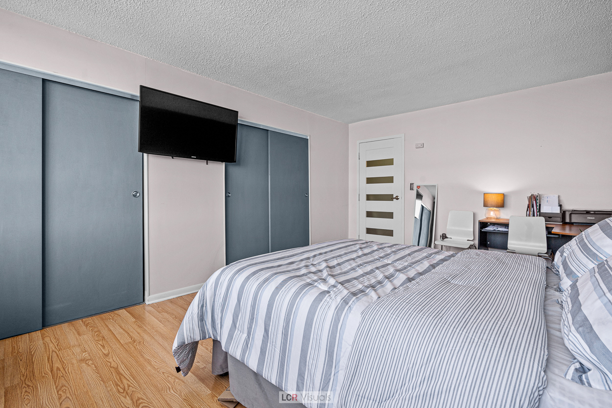 8815 West Golf Road, Unit 10C Niles, IL 60714 - Photo 20 of 27 a bedroom with a bed and a television