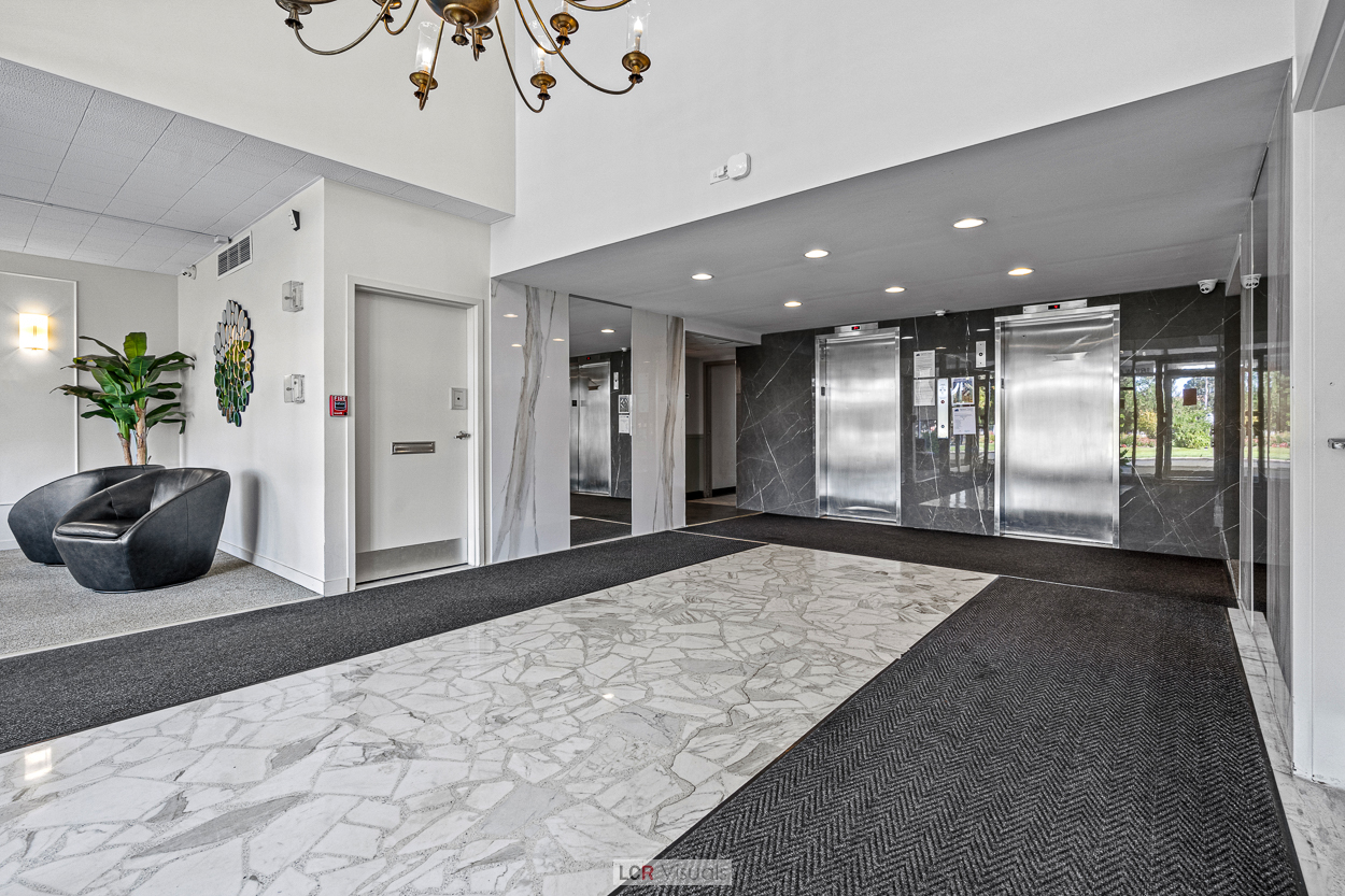 8815 West Golf Road, Unit 10C Niles, IL 60714 - Photo 2 of 27 a lobby with a potted plant and a rug