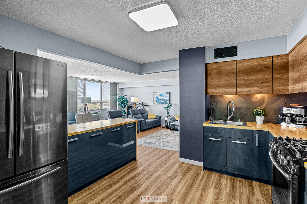 8815 West Golf Road, Unit 10C Niles, IL 60714 - Photo 5 of 27 a kitchen with granite countertop lots of counter top space and stainless steel appliances