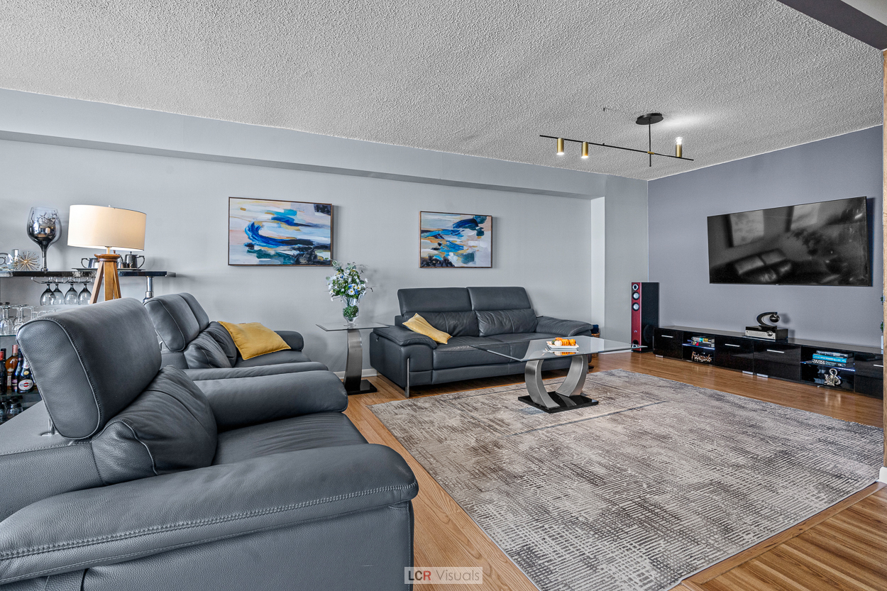 8815 West Golf Road, Unit 10C Niles, IL 60714 - Photo 8 of 27 a living room with furniture and a flat screen tv