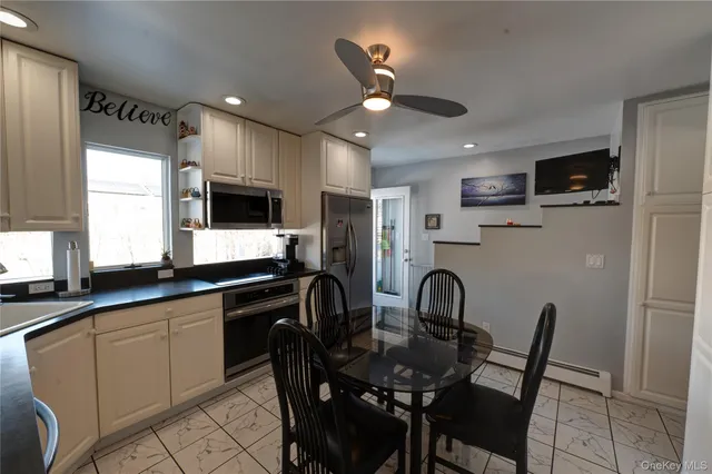 a kitchen with granite countertop white cabinets a sink and stainless steel appliances