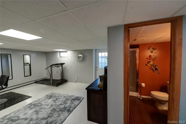 a living room with a toilet and a double vanity sink