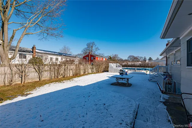 a swimming pool with outdoor seating and yard