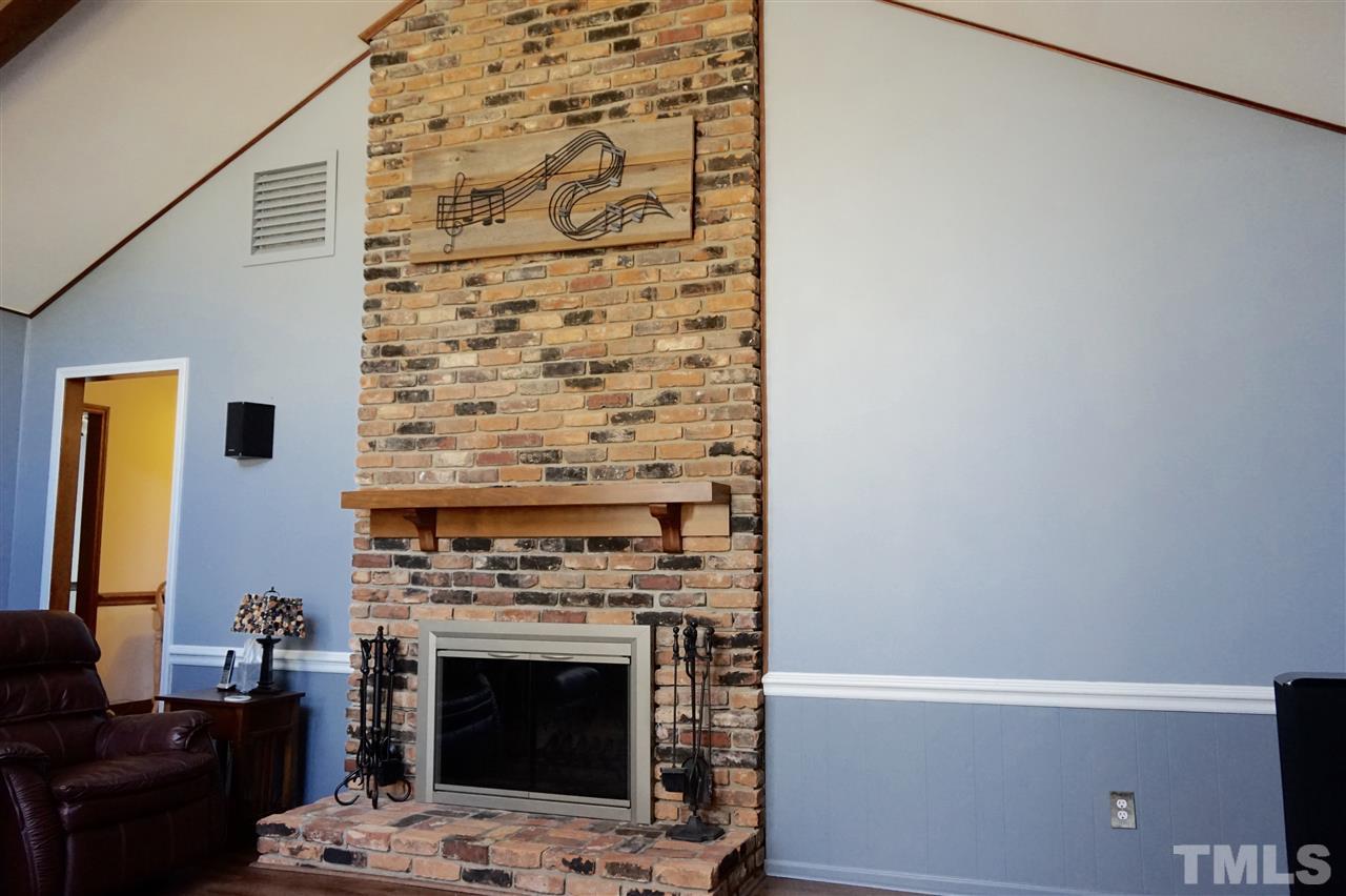 8605 Maidstone Court Raleigh, NC 27613 - Photo 2 of 13 a living room with a fireplace