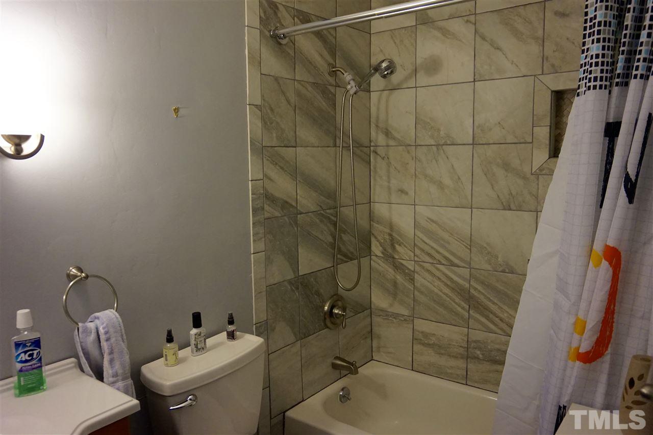 8605 Maidstone Court Raleigh, NC 27613 - Photo 11 of 13 a bathroom with a sink toilet and shower