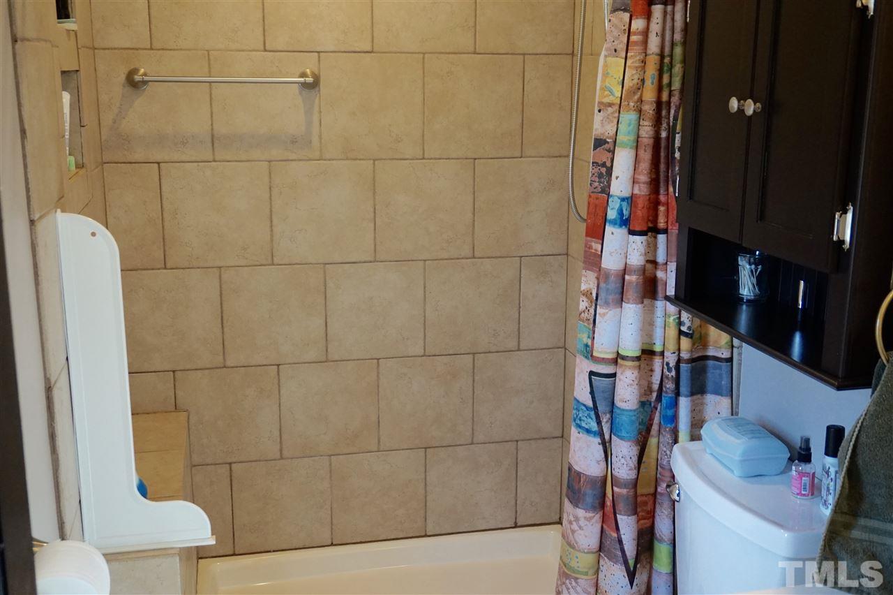 8605 Maidstone Court Raleigh, NC 27613 - Photo 8 of 13 a bathroom with a sink and toilet