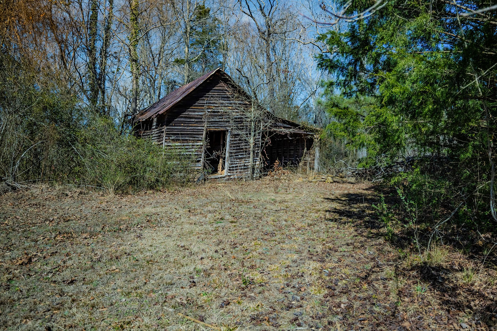 900 Asaville School Road Anderson, SC 29621 - Photo 10 of 29 This rustic structure features classic wooden siding nestled amongst natural landscaping.