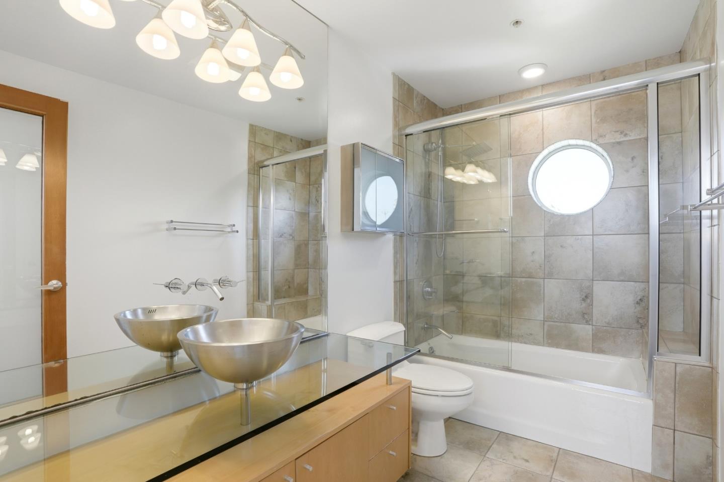 2709 Tenth Street, Unit C Berkeley, CA 94710 - Photo 41 of 44 a bathroom with a toilet a sink a mirror and a bathtub