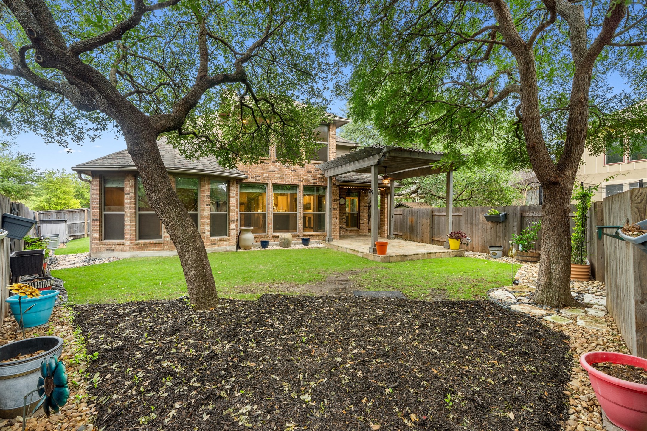 3935 Bowstring Bend Cedar Park, TX 78613 - Photo 35 of 39 Mature trees along the back fence line provide a natural backdrop for the sprawling lawn, creating a private outdoor space for play or quiet afternoons