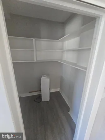 a view of an empty room and a window