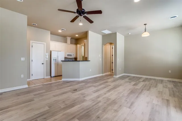 a view of a kitchen with a refrigerator and a sink