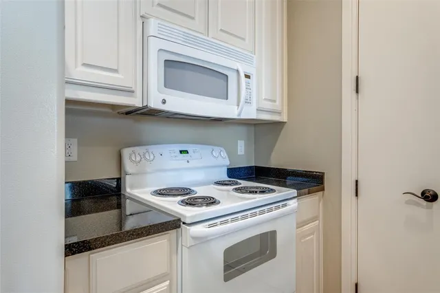 a kitchen with a stove and a microwave