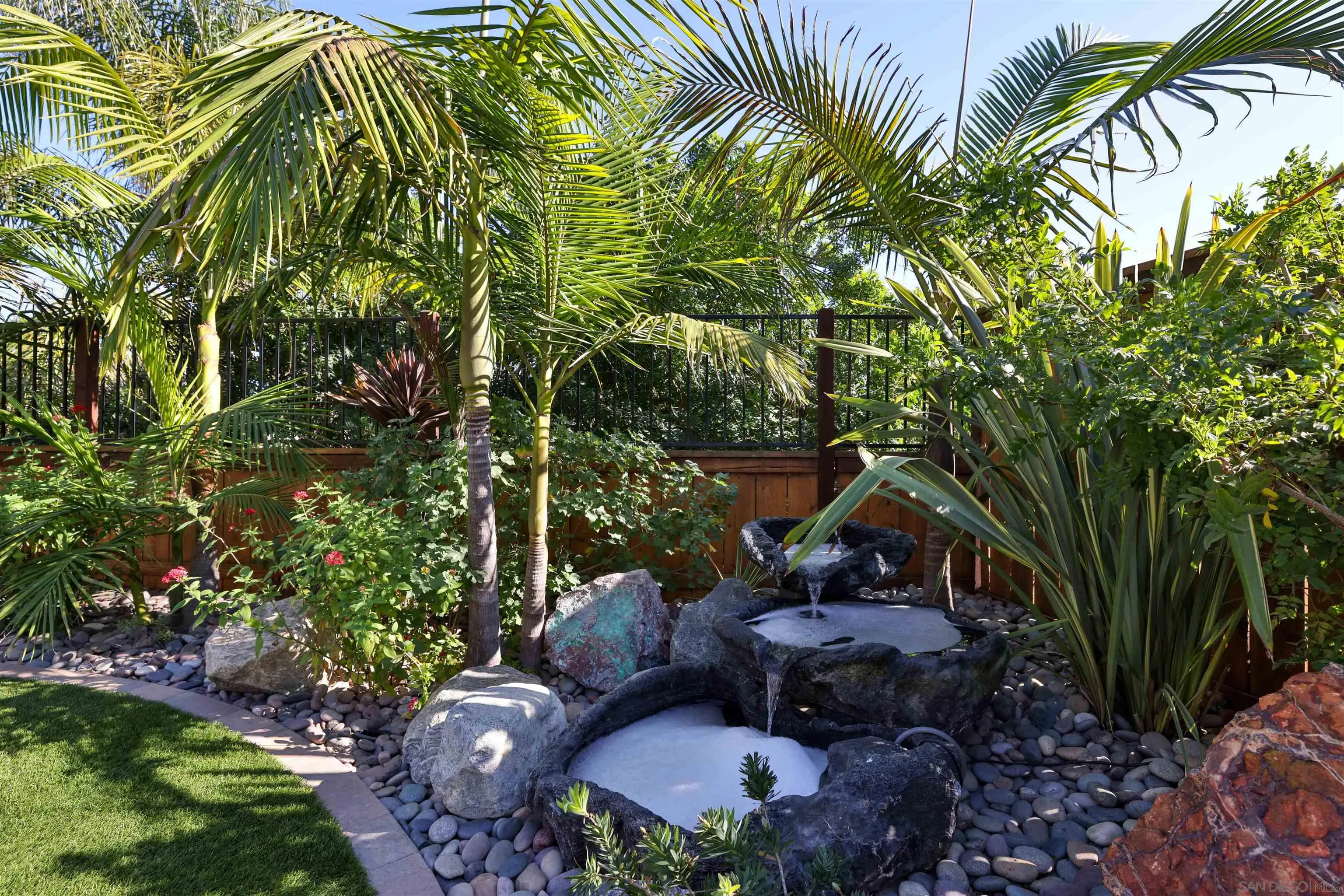 2102 Wandering Road Encinitas, CA 92024 - Photo 28 of 37 a view of a garden with plants and a bench