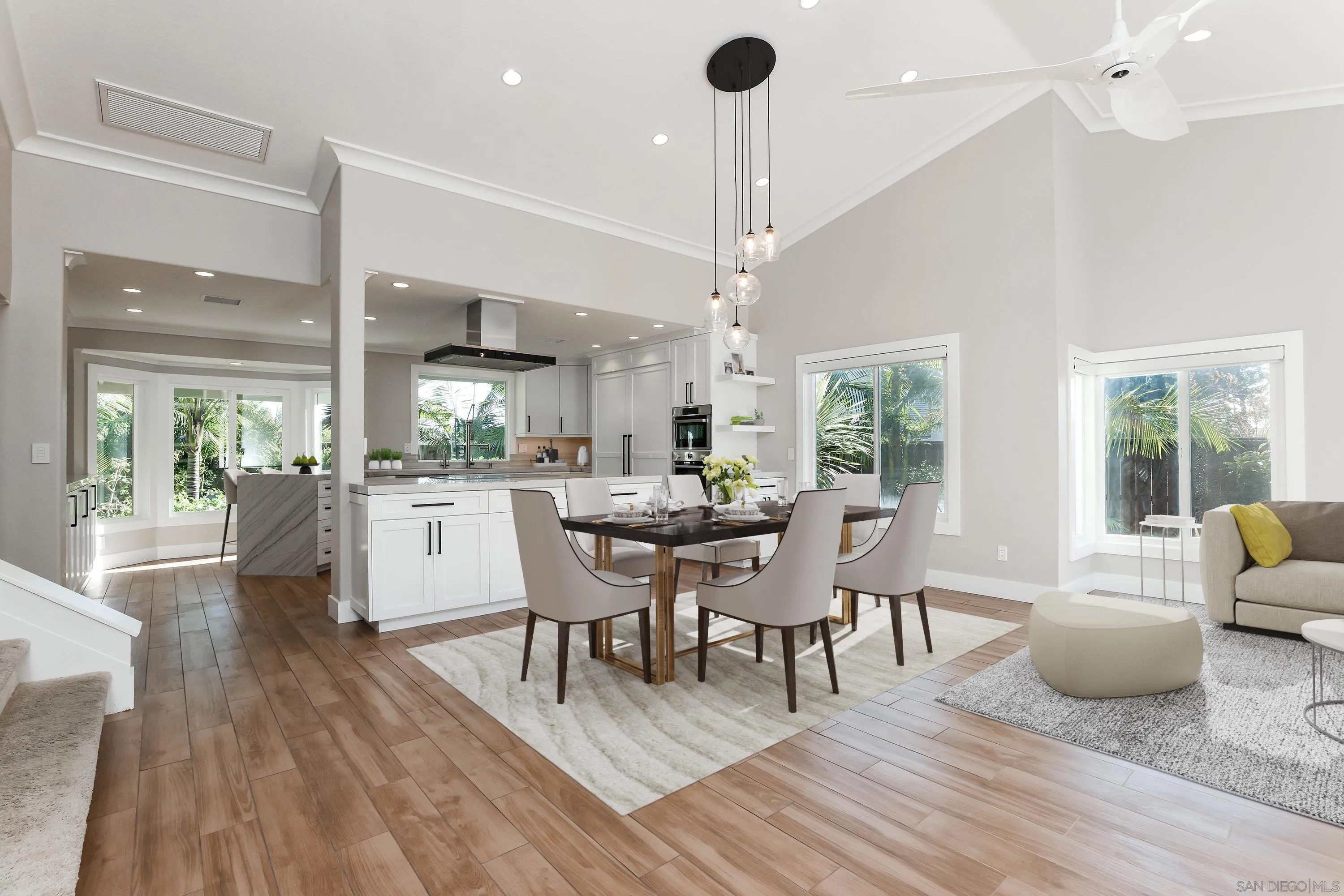 2102 Wandering Road Encinitas, CA 92024 - Photo 3 of 37 a dining room with furniture a chandelier and wooden floor