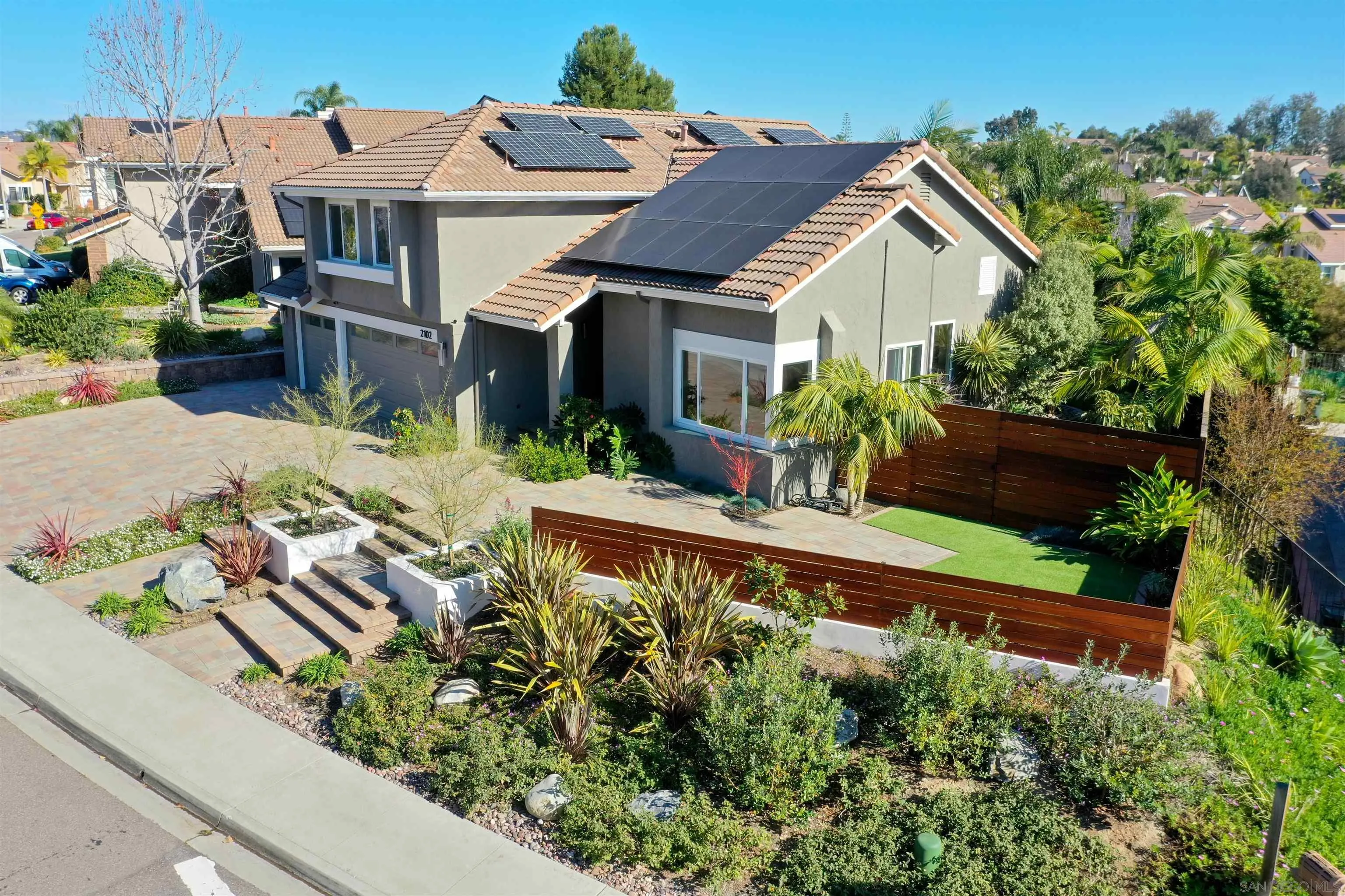 2102 Wandering Road Encinitas, CA 92024 - Photo 36 of 37 a view of a house with a small yard and potted plants