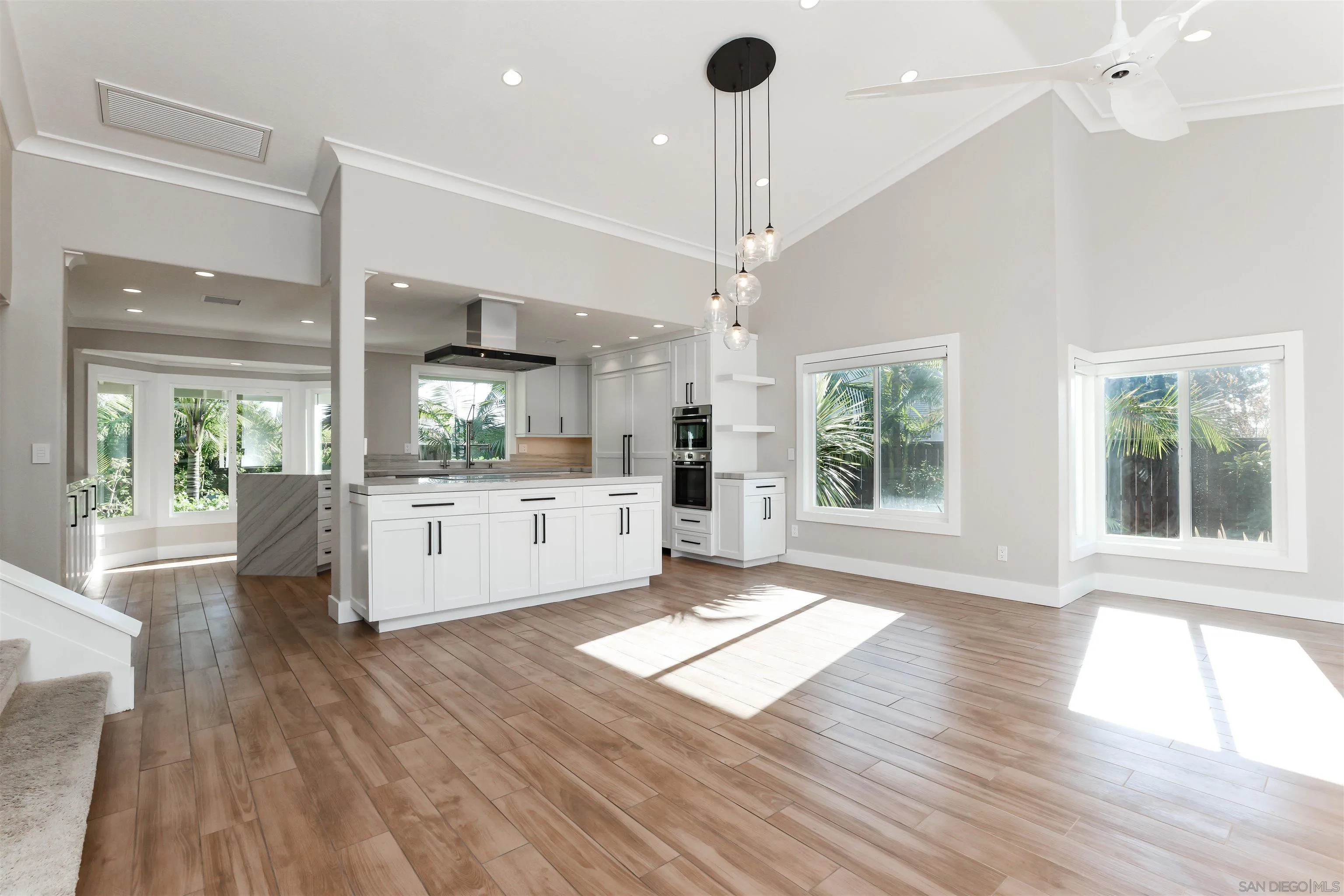 2102 Wandering Road Encinitas, CA 92024 - Photo 4 of 37 a large white kitchen with wooden floors