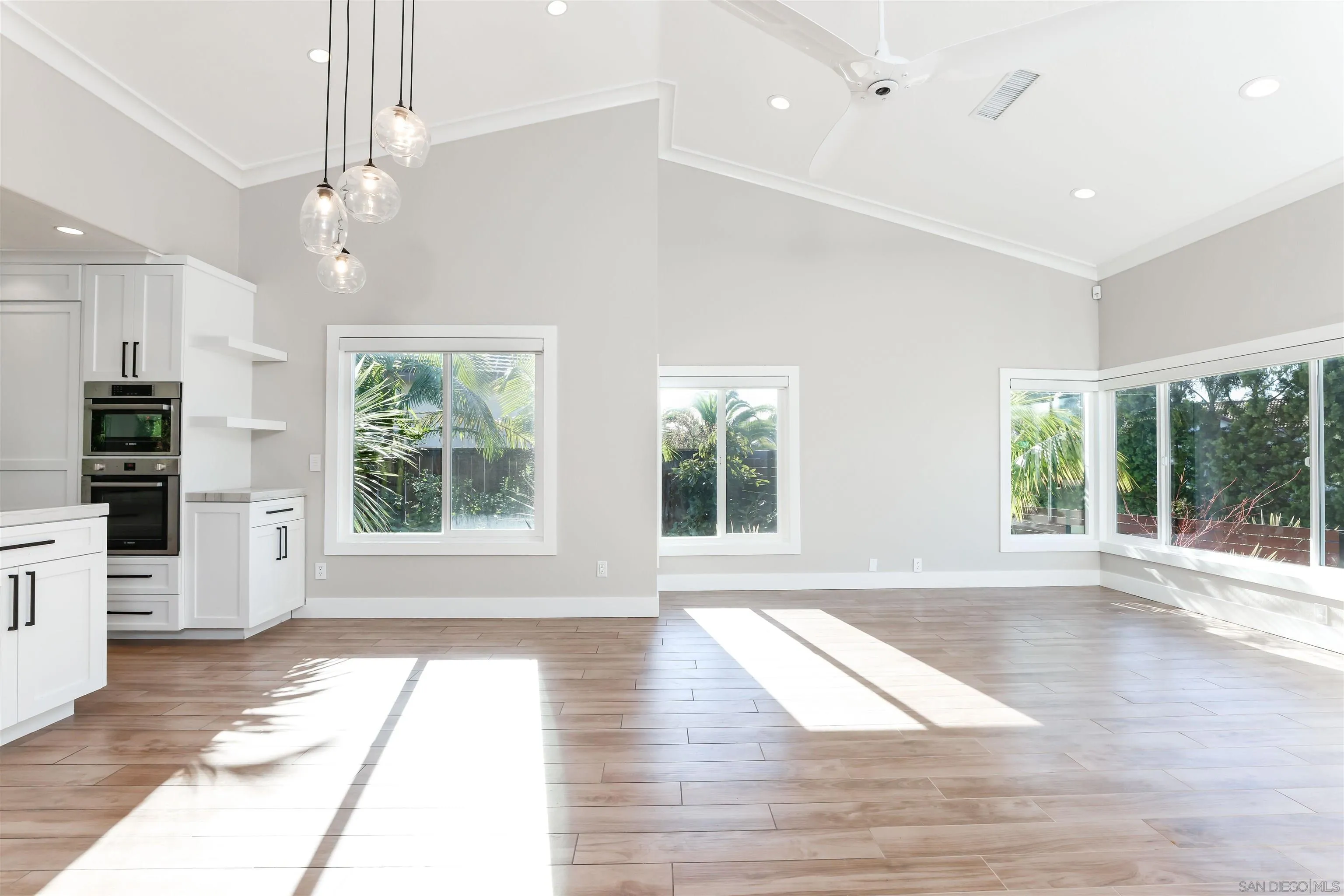 2102 Wandering Road Encinitas, CA 92024 - Photo 6 of 37 an empty room with wooden floor and windows