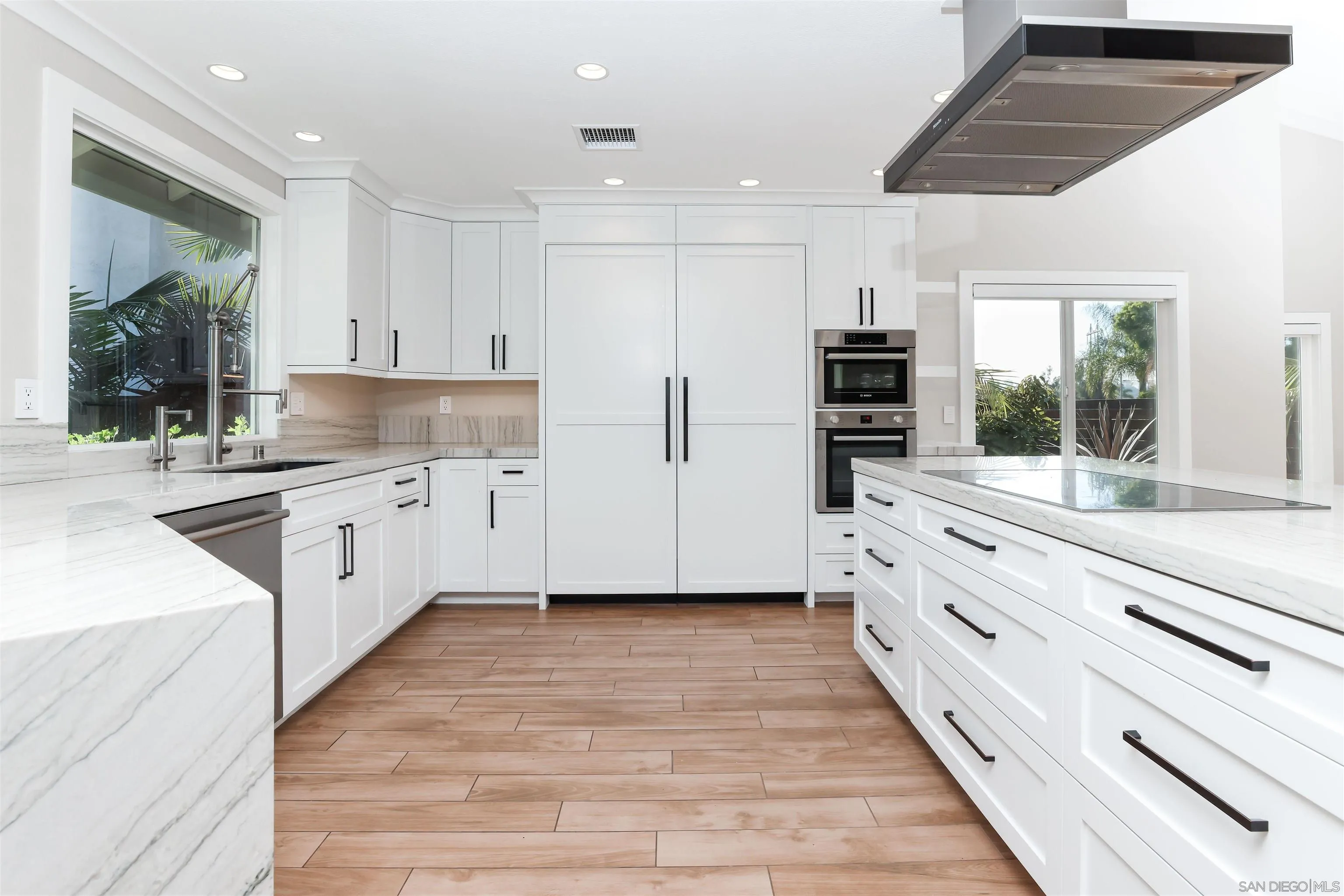 2102 Wandering Road Encinitas, CA 92024 - Photo 8 of 37 a kitchen with stainless steel appliances kitchen island granite countertop a stove and a sink