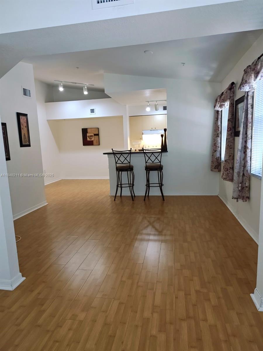 2586 Centergate Drive, Unit 307 Miramar, FL 33025 - Photo 14 of 43 a view of a livingroom with furniture wooden floor and a window