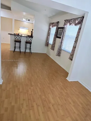 a view of a room with furniture wooden floor and window