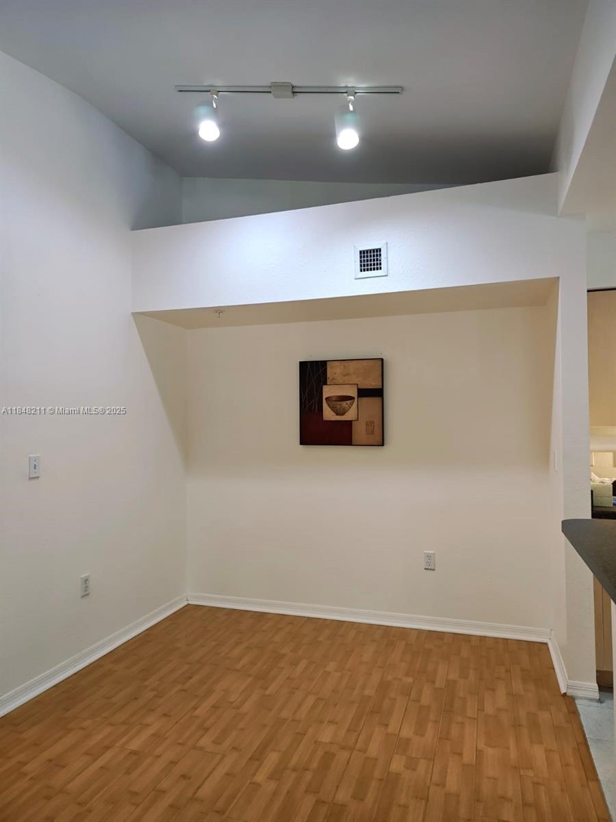 2586 Centergate Drive, Unit 307 Miramar, FL 33025 - Photo 19 of 43 an empty room with wooden floor
