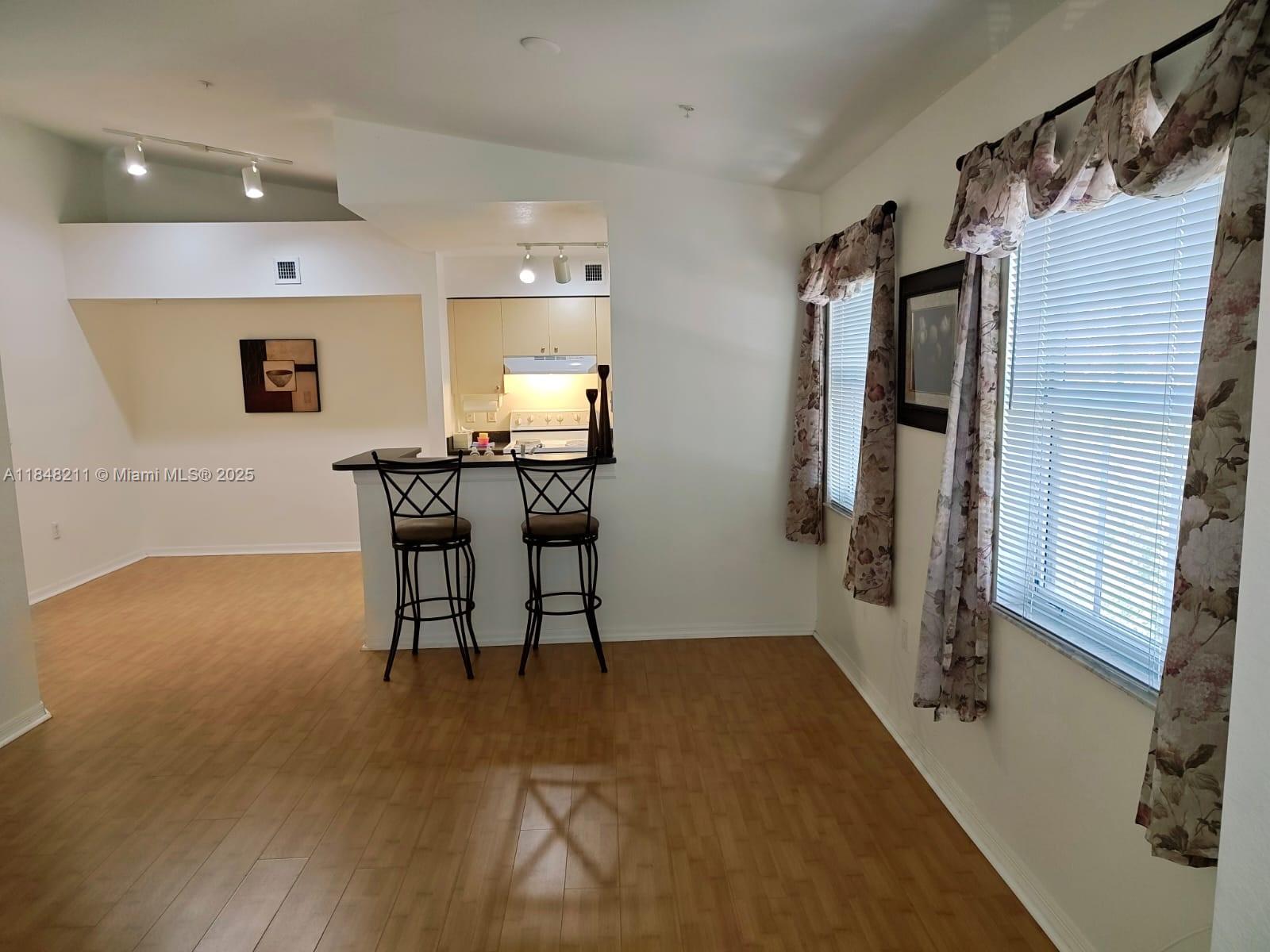 2586 Centergate Drive, Unit 307 Miramar, FL 33025 - Photo 21 of 43 a view of a room with furniture and wooden floor