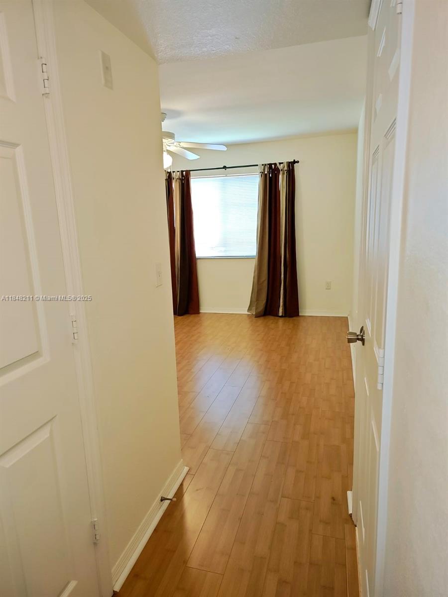 2586 Centergate Drive, Unit 307 Miramar, FL 33025 - Photo 24 of 43 a view of a room with wooden floor and a window