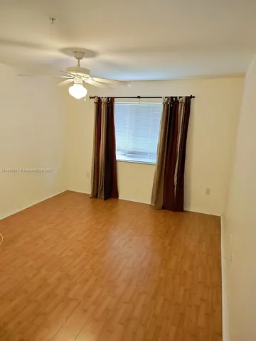 a view of a room with a refrigerator
