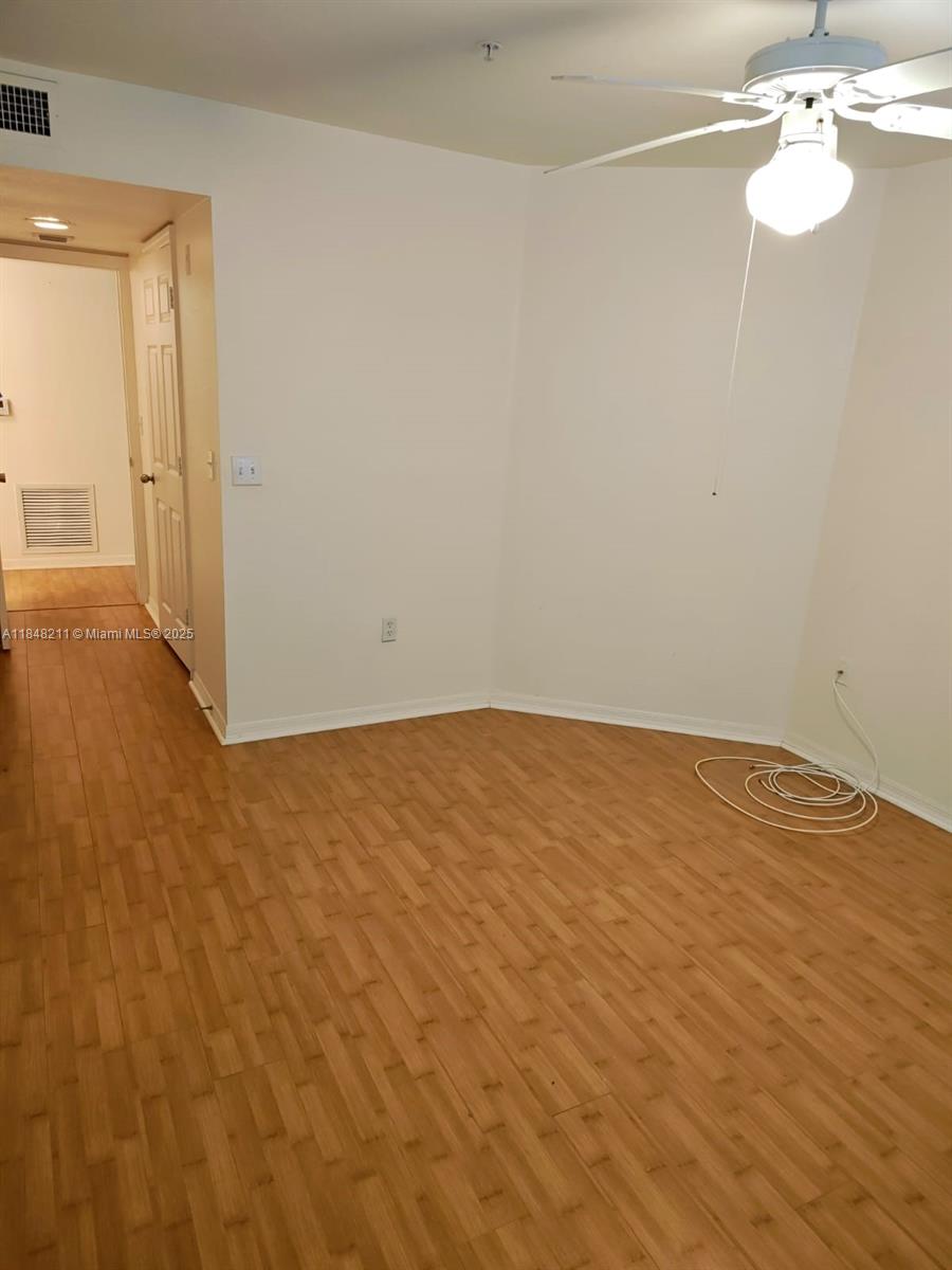 2586 Centergate Drive, Unit 307 Miramar, FL 33025 - Photo 26 of 43 a view of empty room with wooden floor