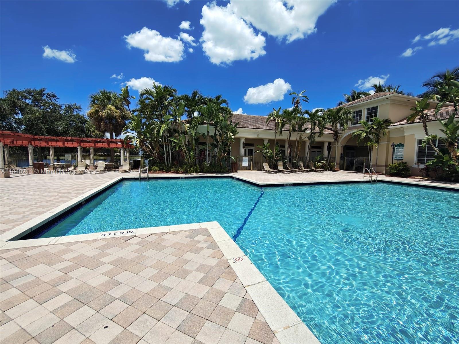 2586 Centergate Drive, Unit 307 Miramar, FL 33025 - Photo 38 of 43 a view of a house with a yard