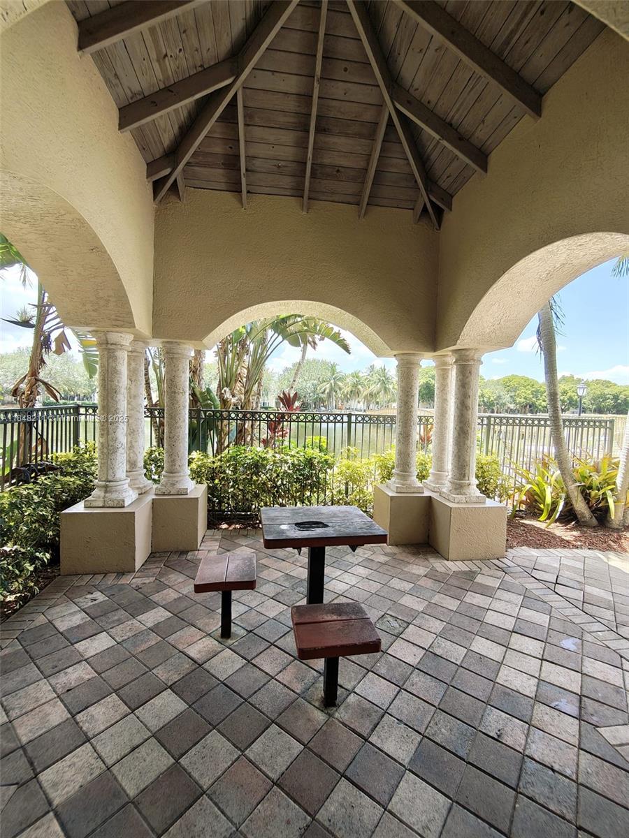 2586 Centergate Drive, Unit 307 Miramar, FL 33025 - Photo 40 of 43 a building outdoor space with patio furniture and a potted plant