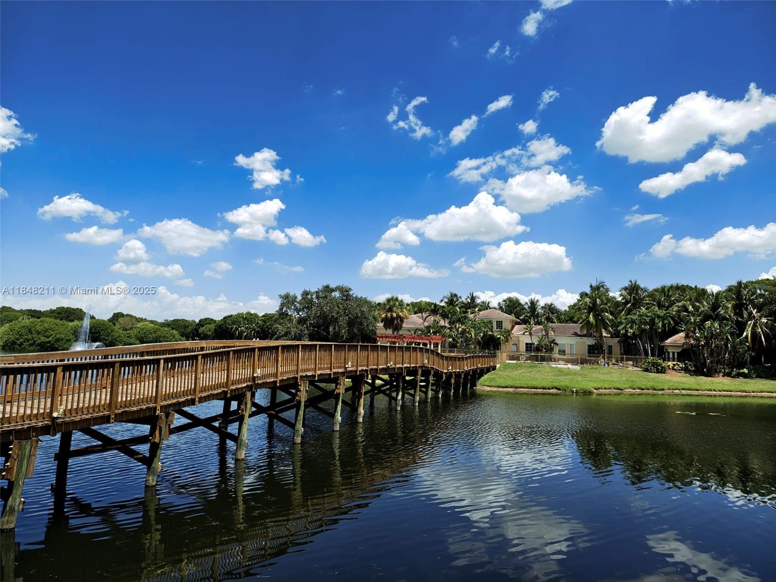 2586 Centergate Drive, Unit 307 Miramar, FL 33025 - Photo 43 of 43 a view of a lake with a table under an ocean view