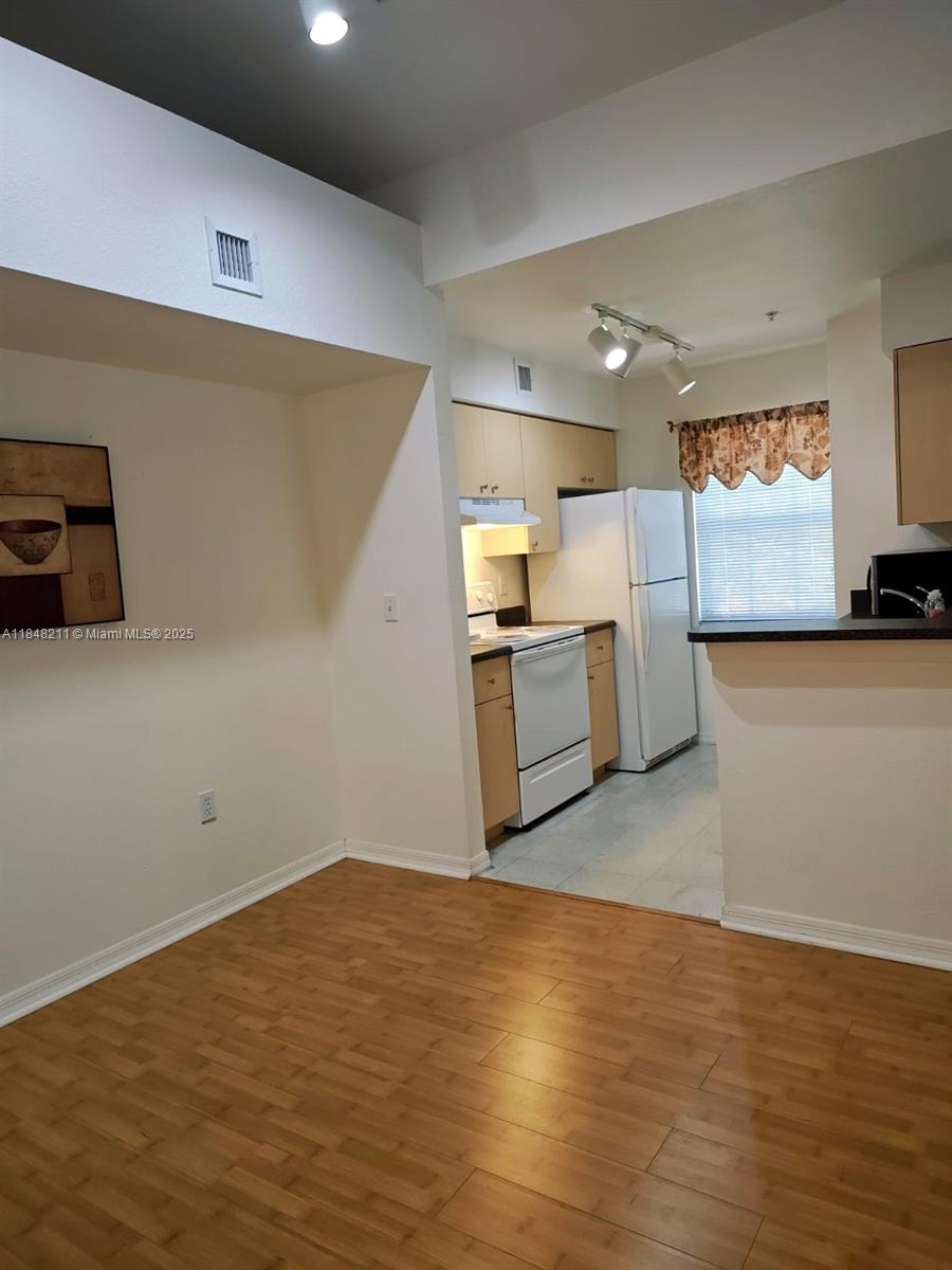 2586 Centergate Drive, Unit 307 Miramar, FL 33025 - Photo 6 of 43 a view of a kitchen with furniture and stainless steel appliances
