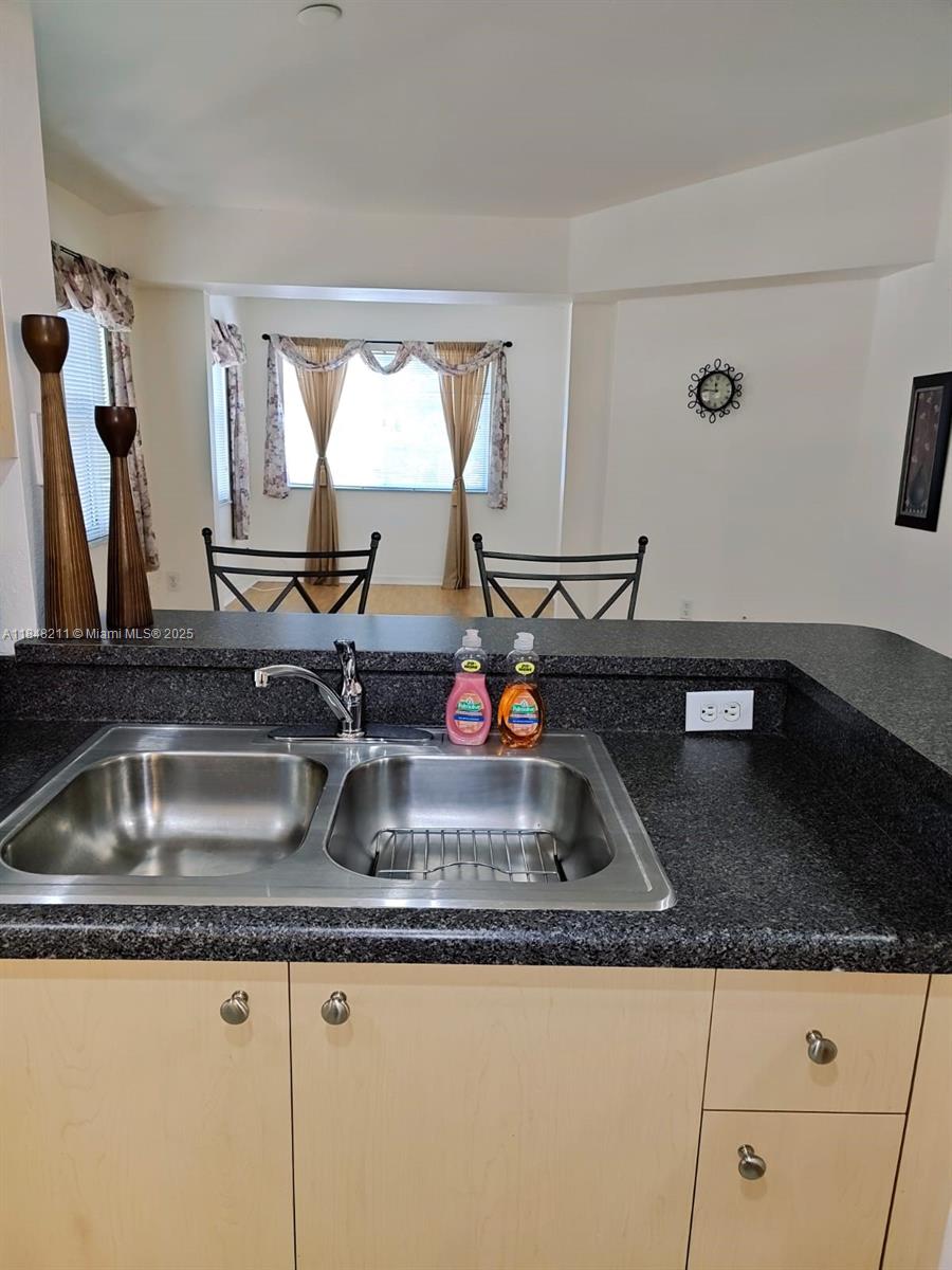 2586 Centergate Drive, Unit 307 Miramar, FL 33025 - Photo 8 of 43 a kitchen with sink and a window
