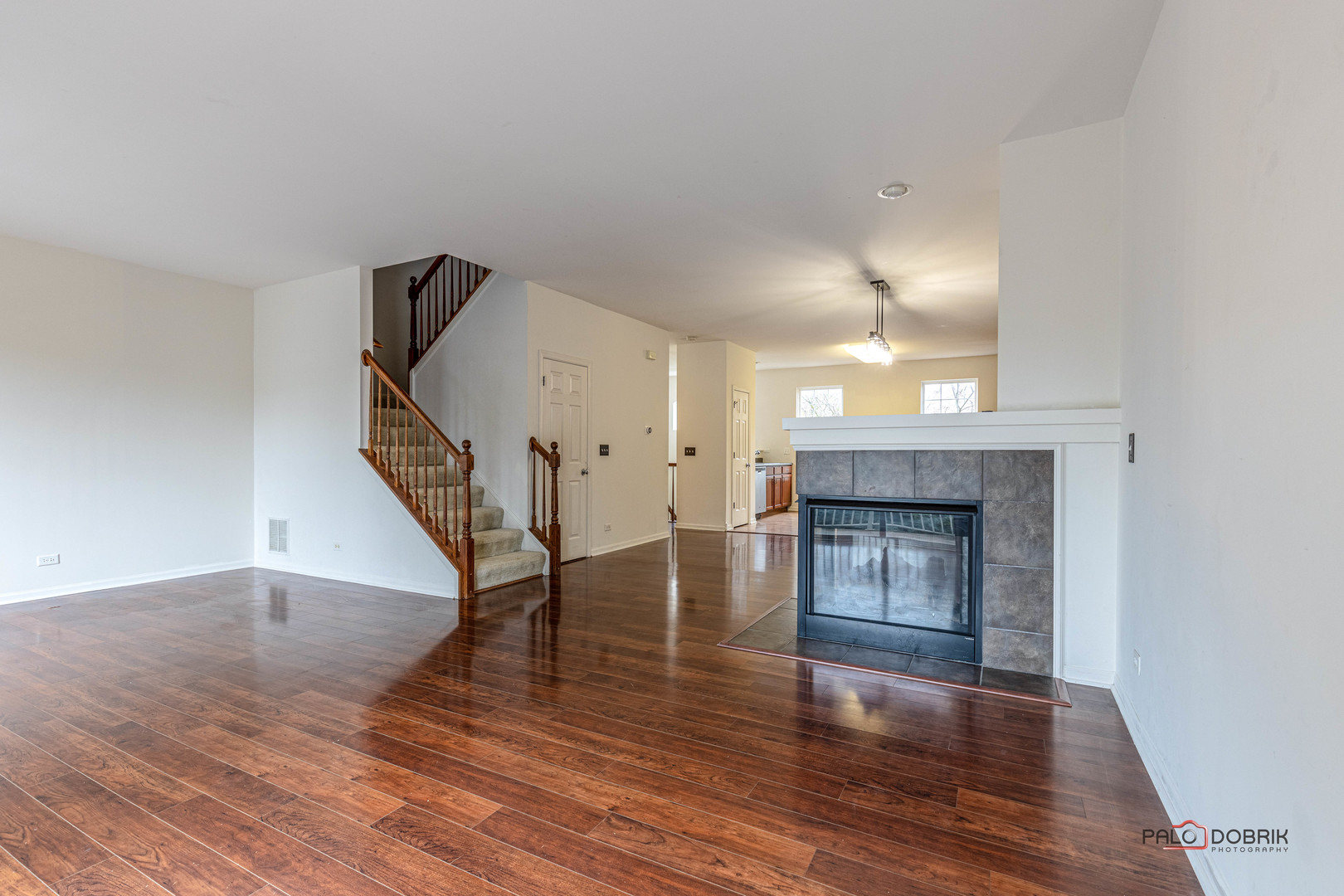 260 Comstock Drive, Unit 260 Elgin, IL 60124 - Photo 12 of 30 a view of an empty room with wooden floor fireplace and a window