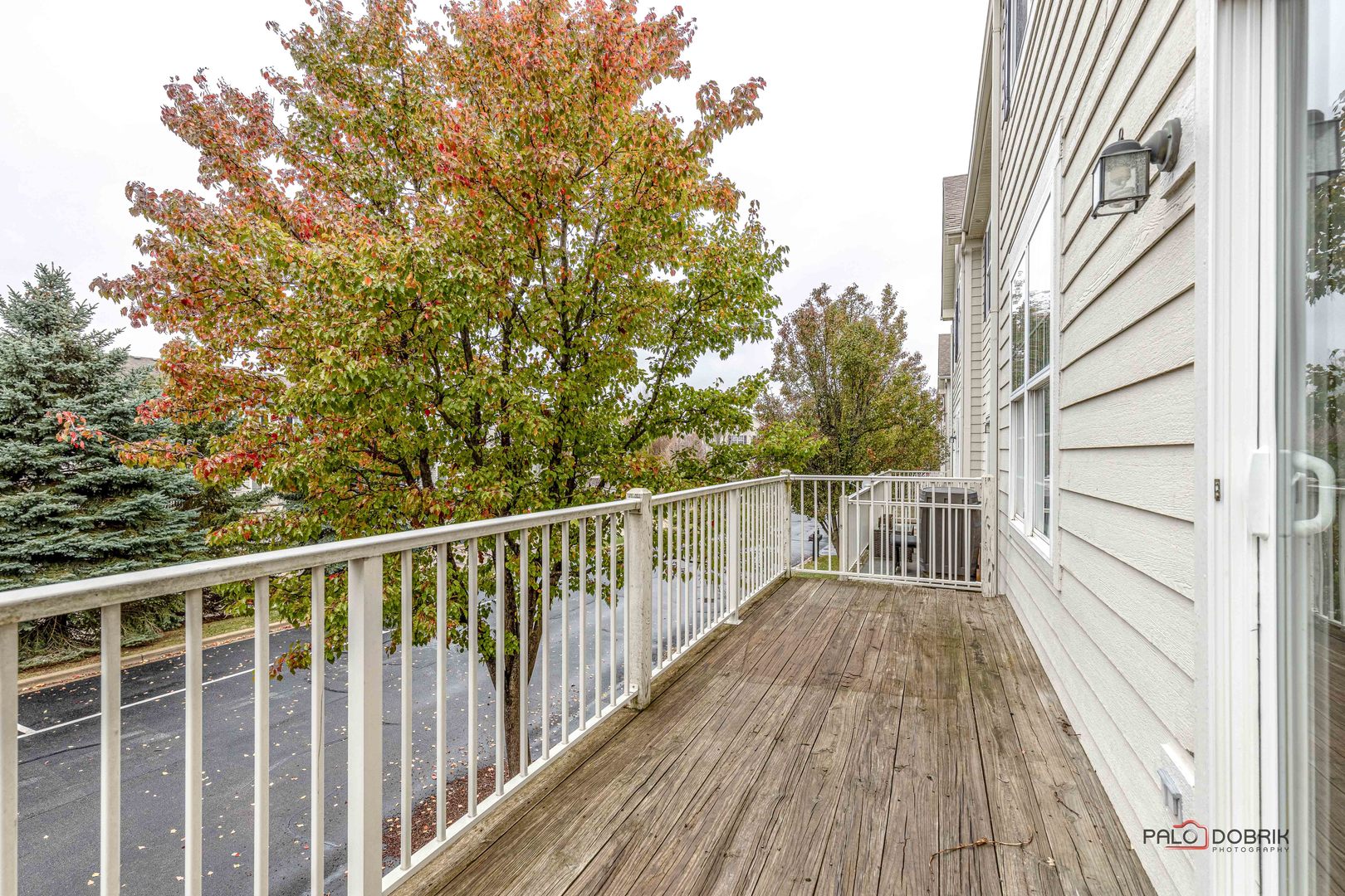 260 Comstock Drive, Unit 260 Elgin, IL 60124 - Photo 13 of 30 a view of deck with wooden floor and fence