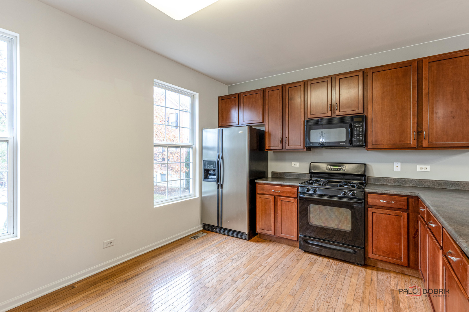 260 Comstock Drive, Unit 260 Elgin, IL 60124 - Photo 15 of 30 a kitchen with stainless steel appliances granite countertop a stove a sink and a refrigerator