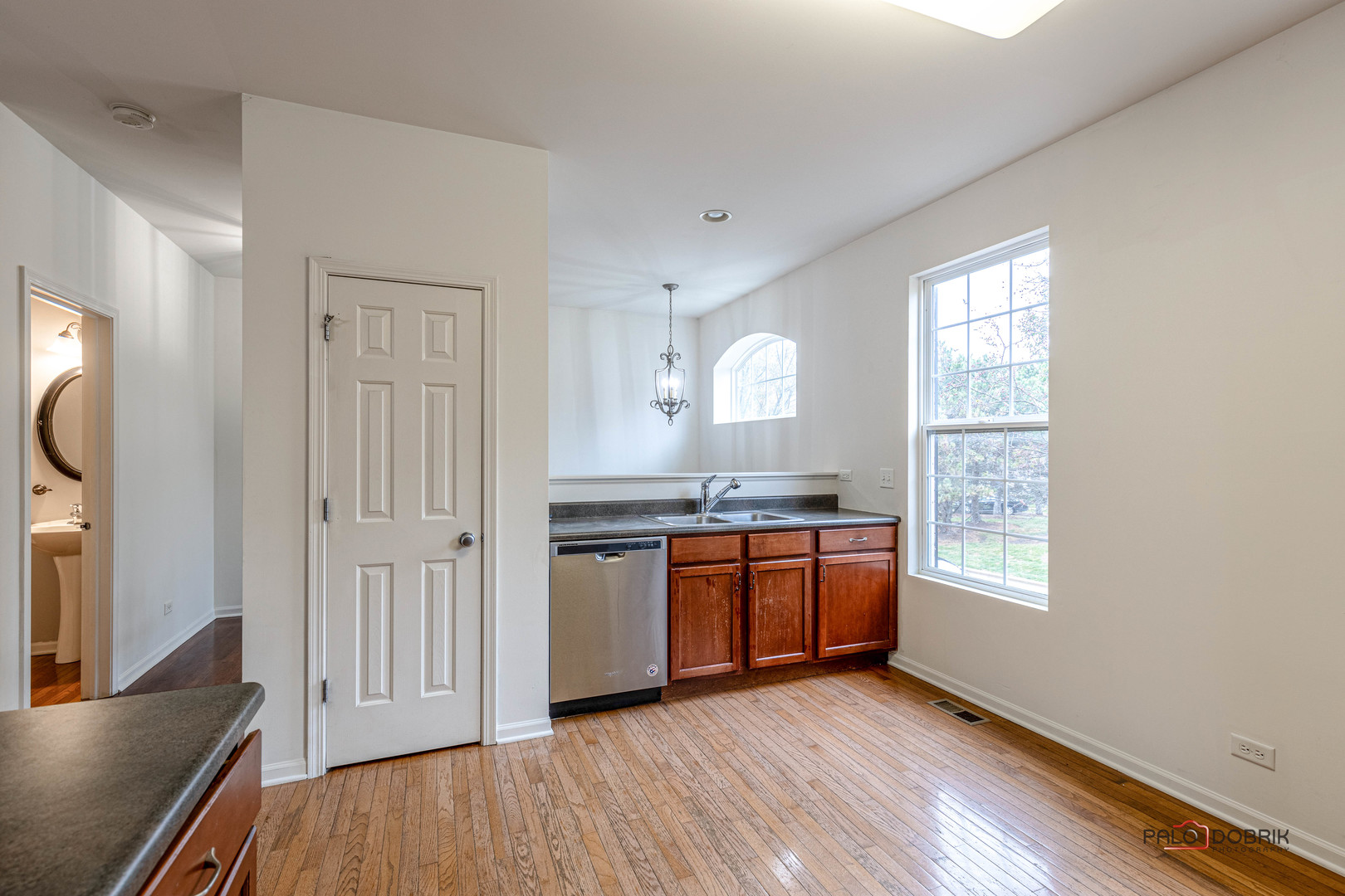 260 Comstock Drive, Unit 260 Elgin, IL 60124 - Photo 16 of 30 a kitchen with stainless steel appliances granite countertop a stove a sink and a refrigerator with wooden floors