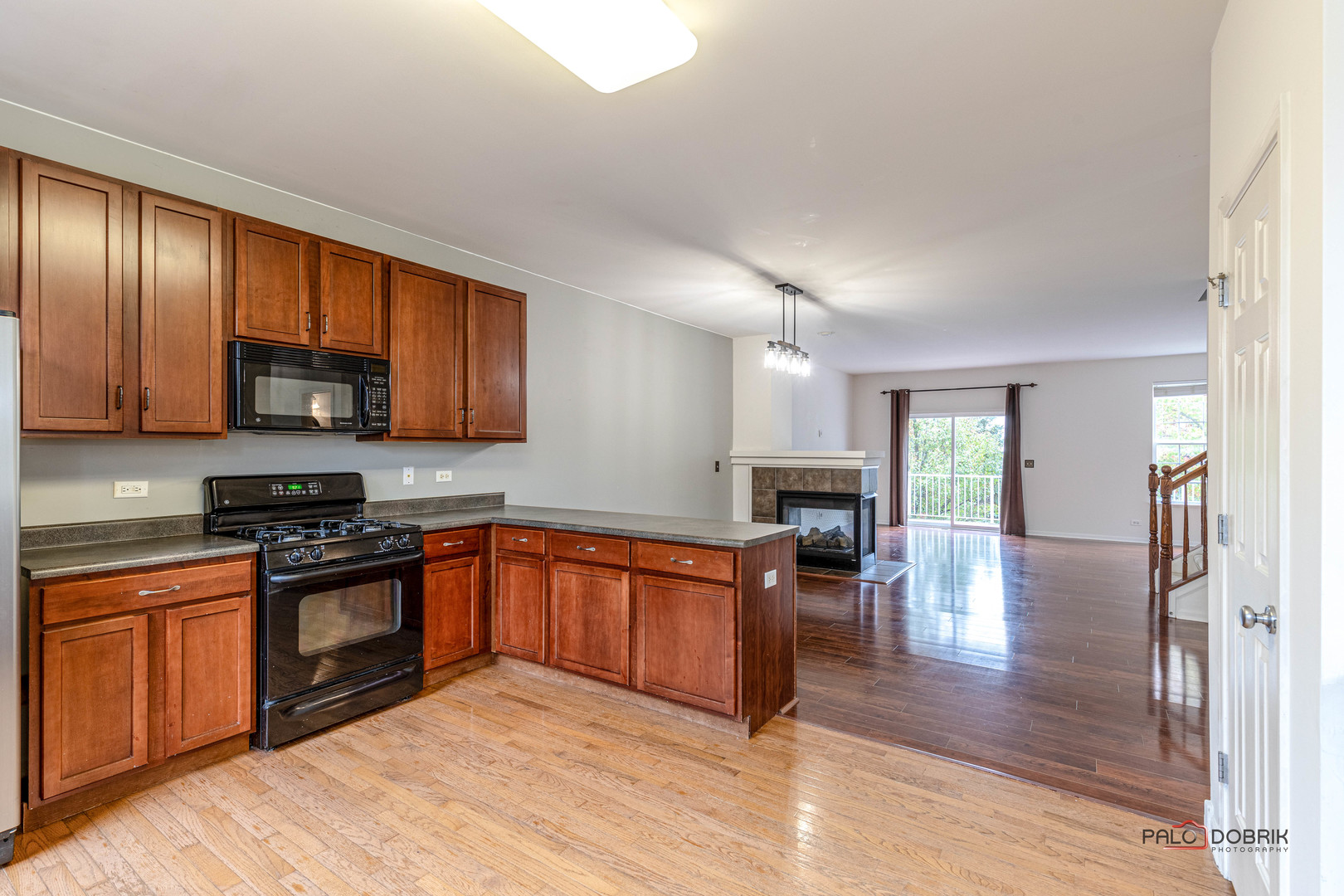 260 Comstock Drive, Unit 260 Elgin, IL 60124 - Photo 18 of 30 a kitchen with stainless steel appliances granite countertop wooden cabinets a stove top oven a sink and dishwasher