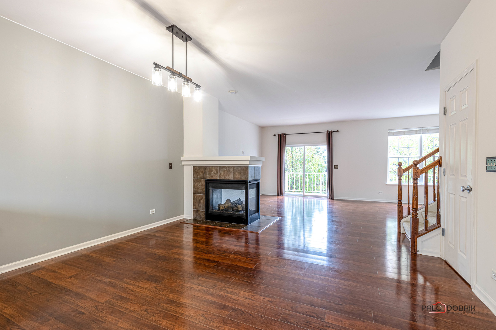 260 Comstock Drive, Unit 260 Elgin, IL 60124 - Photo 6 of 30 a view of main area fire place window and wooden floor