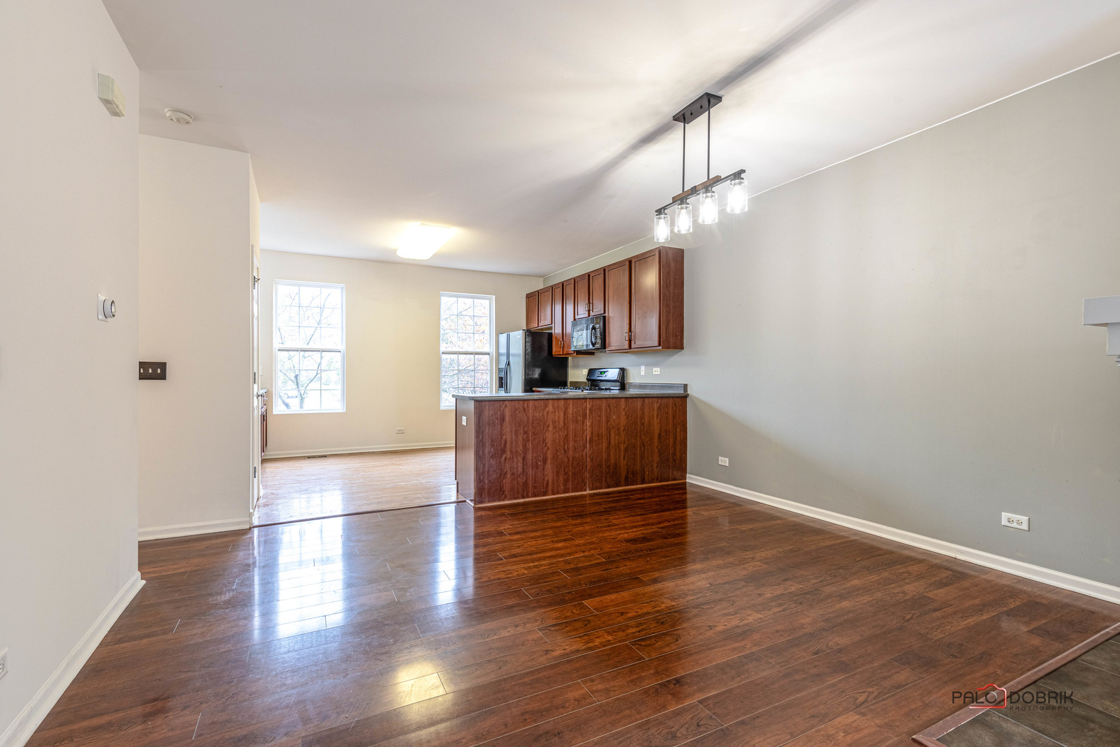 260 Comstock Drive, Unit 260 Elgin, IL 60124 - Photo 8 of 30 a view of a kitchen with wooden floor and a window